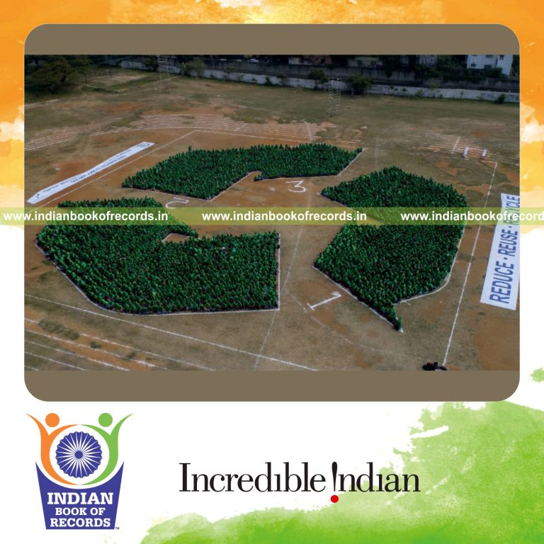 people arranged in a coordinated formation to create the recycling logo symbol for a record in Indian Book of Records
