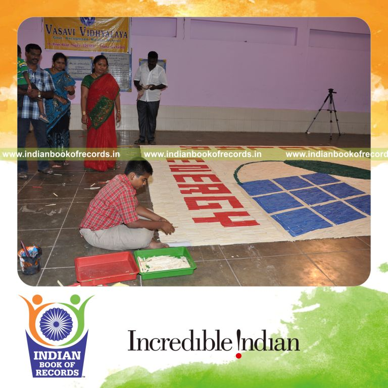 male individual creating large mosaic using ice sticks for record in Indian Book of Records