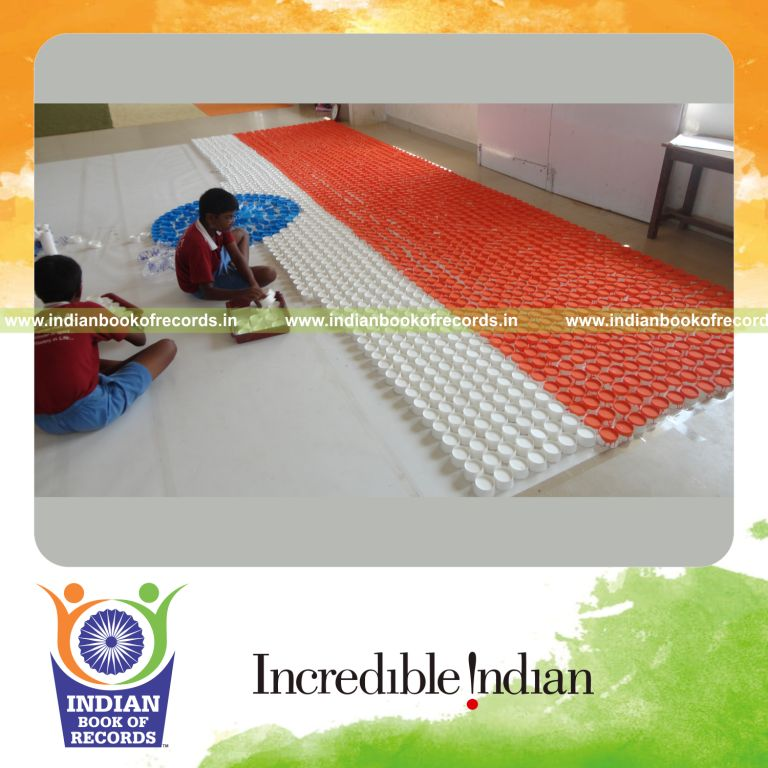 young male creating national flag using paper cups for record in Indian Book of Records