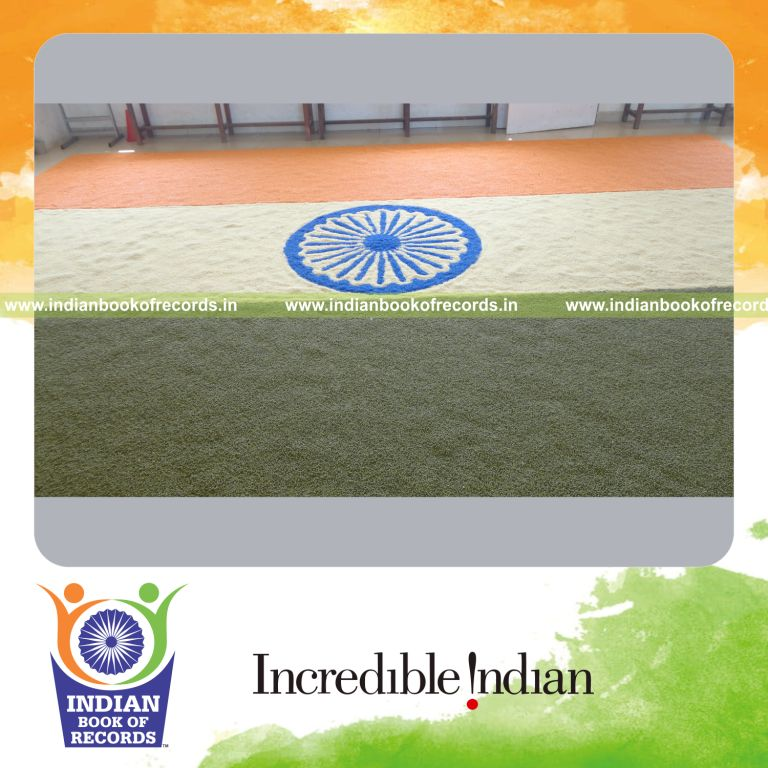 young female creating national flag using grains for record in Indian Book of Records