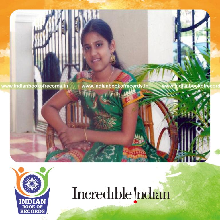 female individual creating mosaic using newspaper clippings and magazines for record in Indian Book of Records