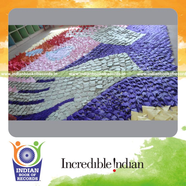 young female creating large mosaic using origami for record in Indian Book of Records