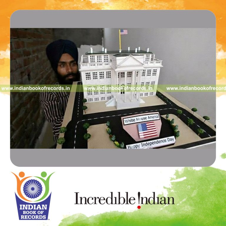 male individual creating paper model of white house for record in Indian Book of Records