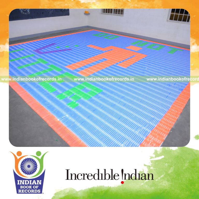 young boy creating mosaic using pens for Indian Book of Records