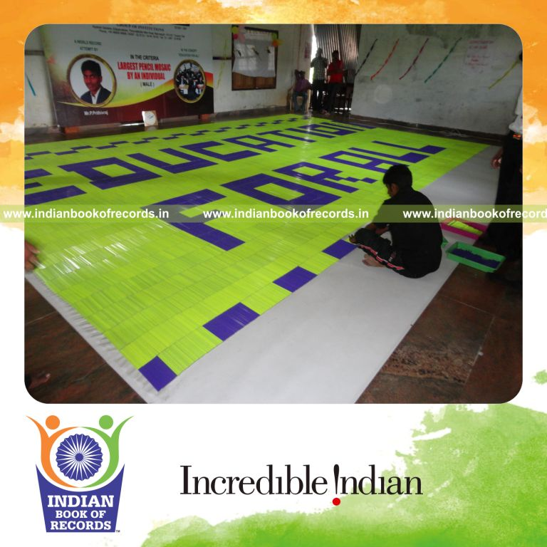 male individual creating large pencil mosaic artwork for record in Indian Book of Records