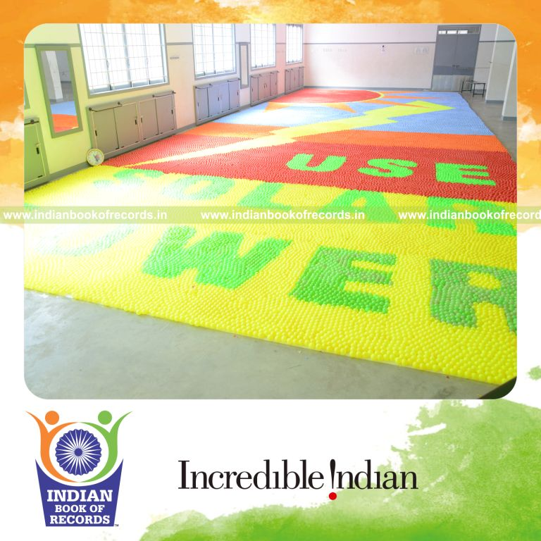 young girl creating mosaic using plastic balls for Indian Book of Records