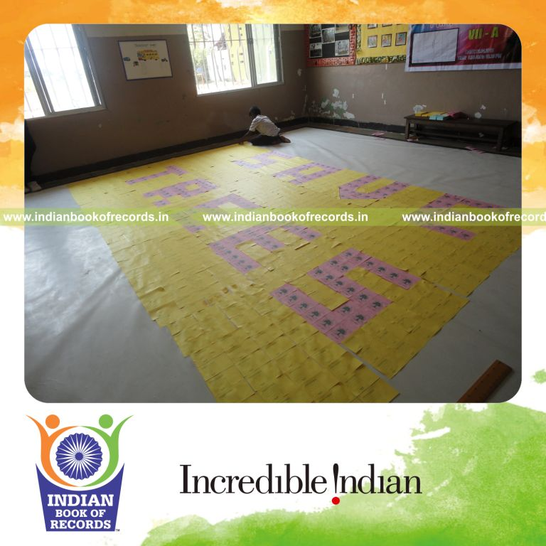 young male creating large mosaic using postcards for record in Indian Book of Records