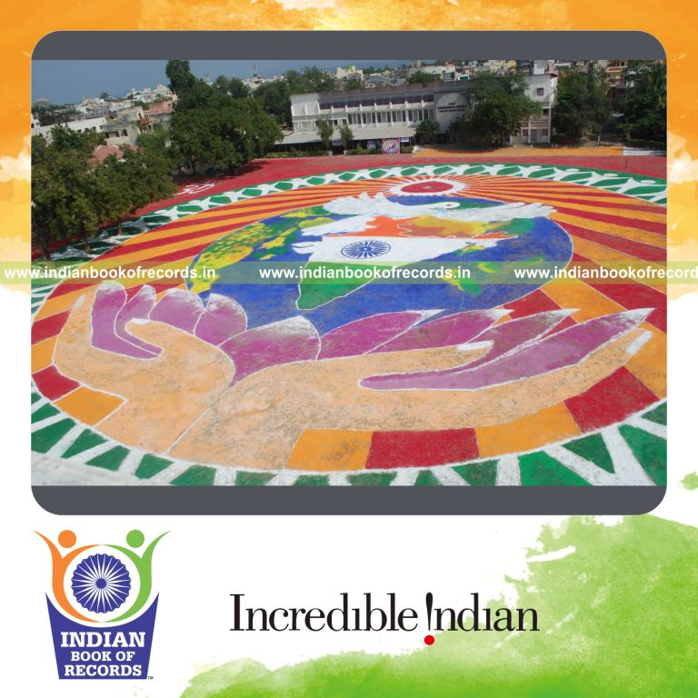 female individual creating a large rangoli design for record in Indian Book of Records
