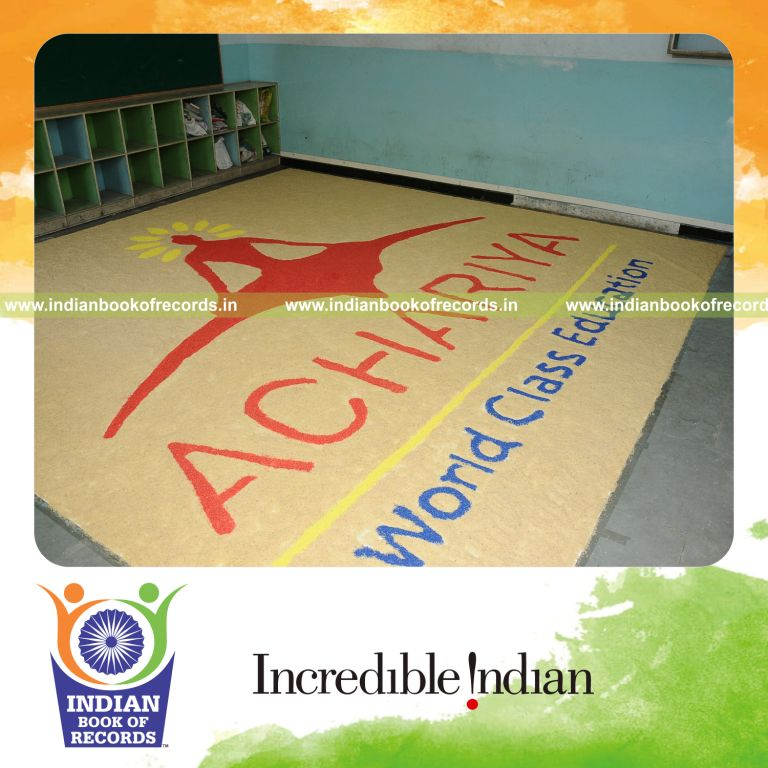 young female creating large mosaic using rice for record in Indian Book of Records