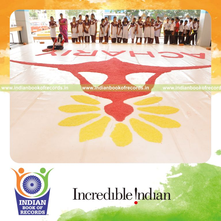 young female creating large mosaic using salt for record in Indian Book of Records