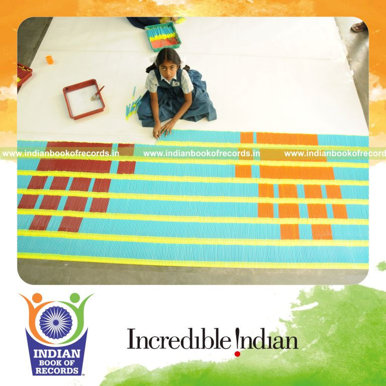young female creating large mosaic using sketch pens for record in Indian Book of Records