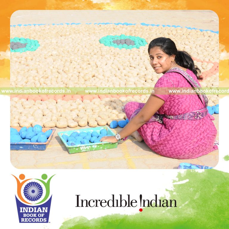 female individual creating large smiley using potatoes for record in Indian Book of Records