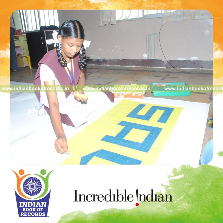young female creating large mosaic using soap for record in Indian Book of Records