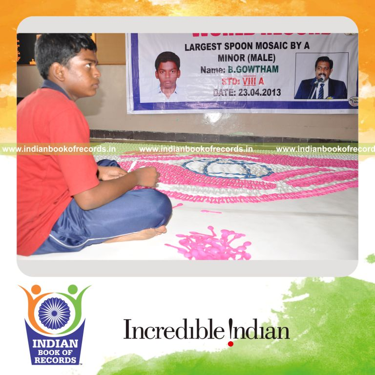 young male creating large mosaic using spoons for record in Indian Book of Records