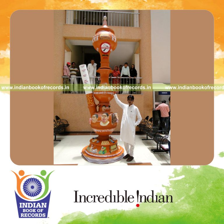 male individual creating a large terracotta hookah replica for record in Indian Book of Records