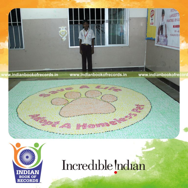 young male creating large thumbprint painting for record in Indian Book of Records