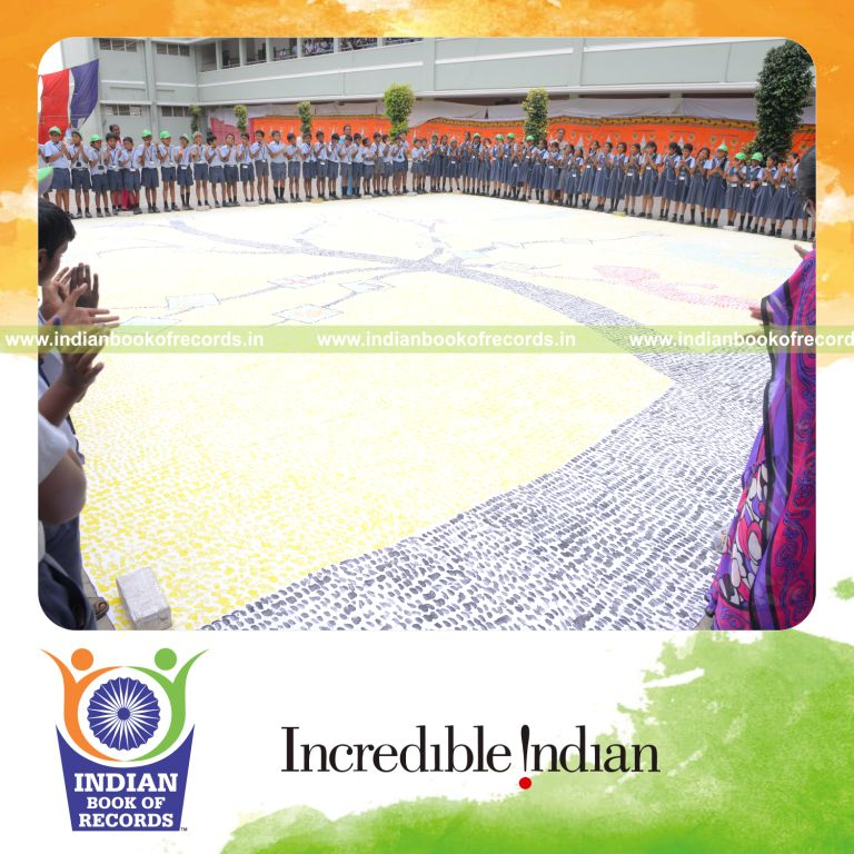young boy creating thumbprint painting artwork for Indian Book of Records
