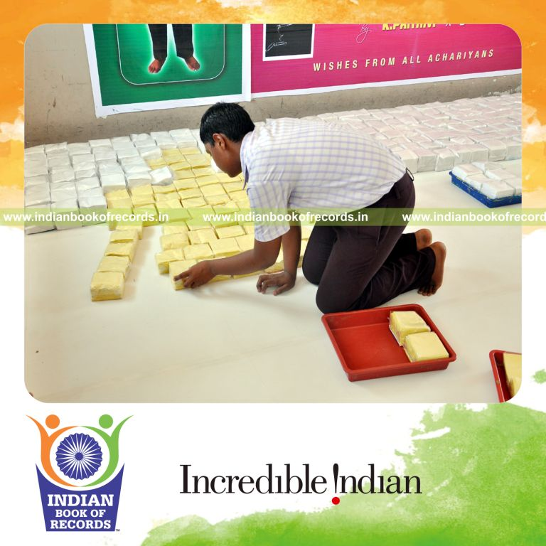 young male creating large mosaic using tissue packs for record in Indian Book of Records