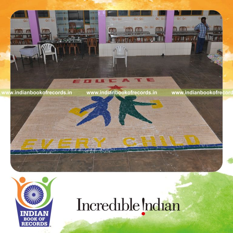 female individual creating large mosaic using toothpicks for record in Indian Book of Records