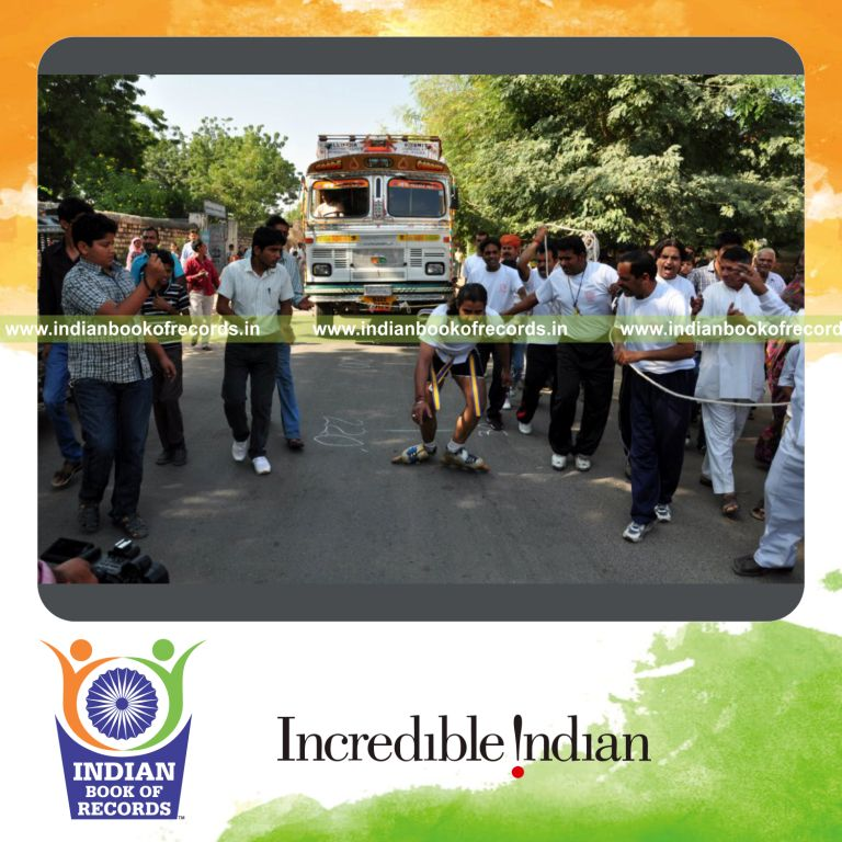 male individual pulling truck while on roller skates for record in Indian Book of Records