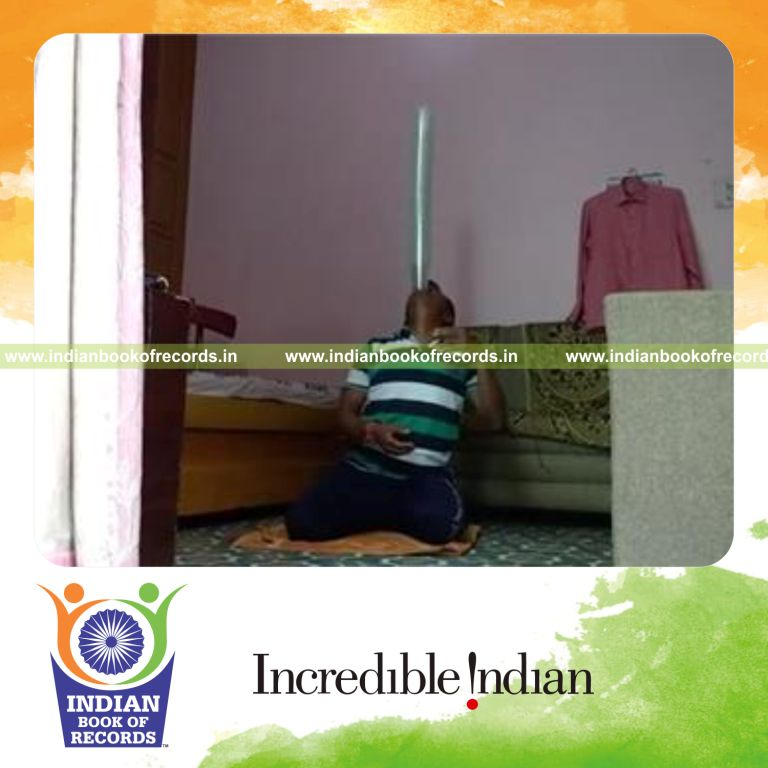 individual balancing multiple juice glasses on chin while kneeling for record in Indian Book of Records