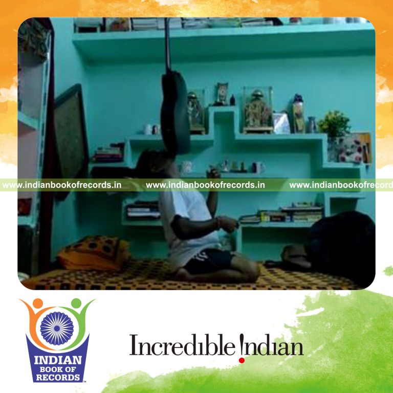 individual balancing acoustic guitar on chin while kneeling for longest duration for record in Indian Book of Records