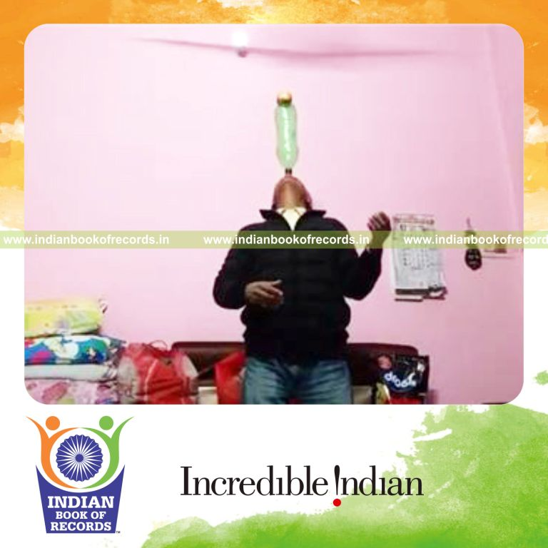 individual balancing apple on two liter bottle on nose for longest time for record in Indian Book of Records