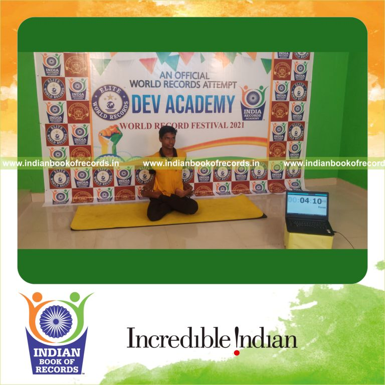 A participant sustaining the Baddha Padmasana yoga pose for an extended period for Indian Book of Records