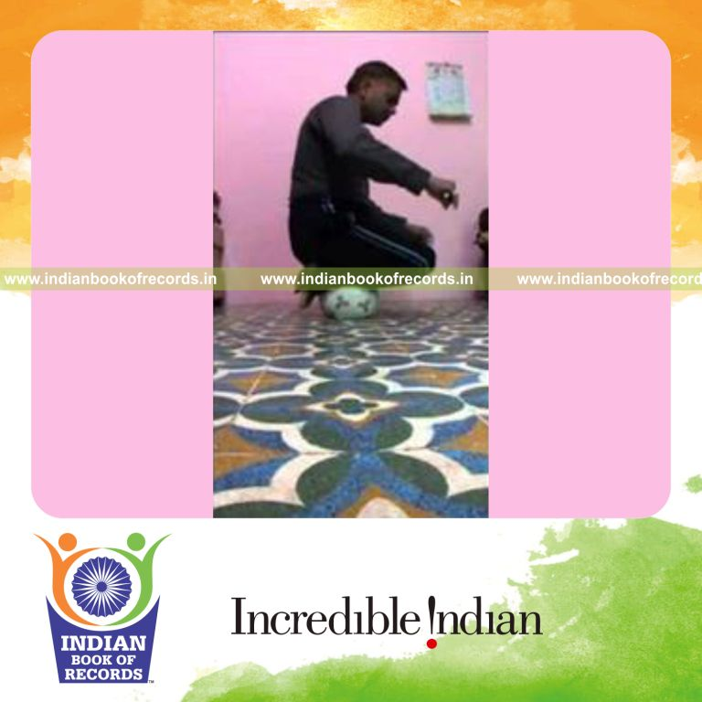individual balancing on soccer ball while holding thunderbolt pose for record in Indian Book of Records