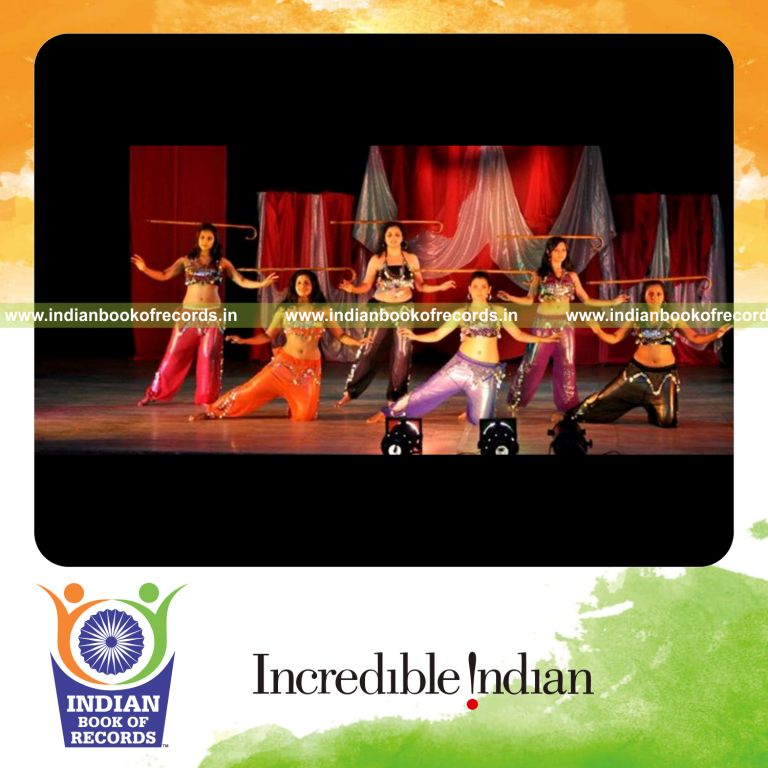 person performing extended balancing act during belly dance for record in Indian Book of Records