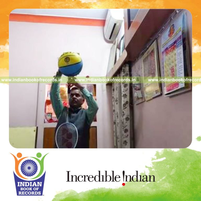 individual balancing basketball on badminton racquet handle on chin for record in Indian Book of Records