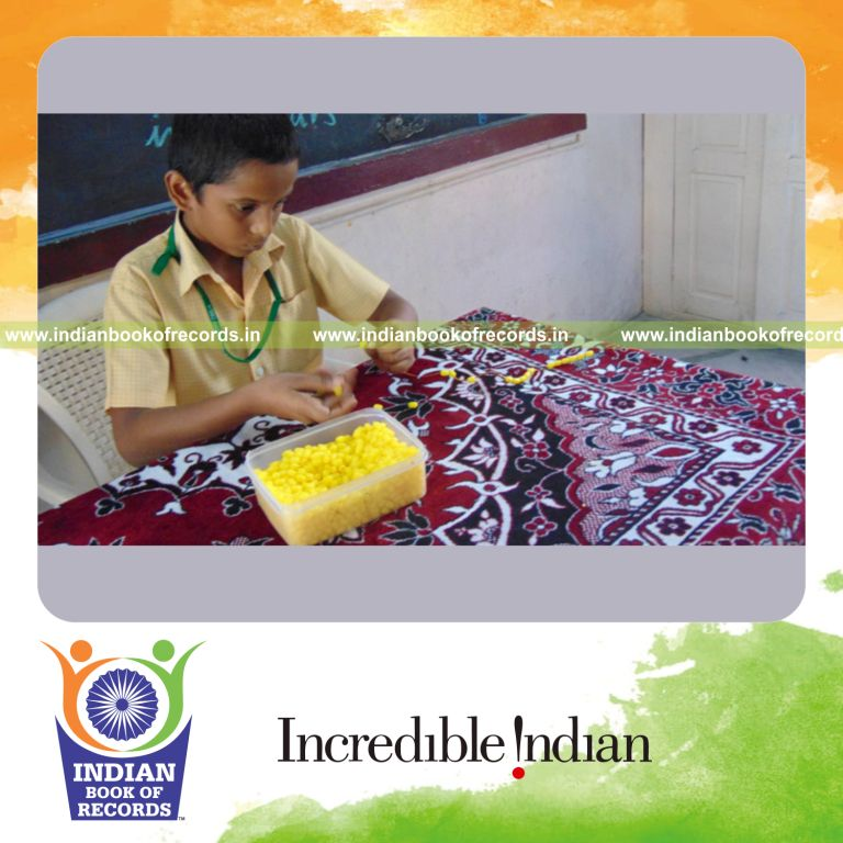 minor male creating long bead string within three hours for Indian Book of Records