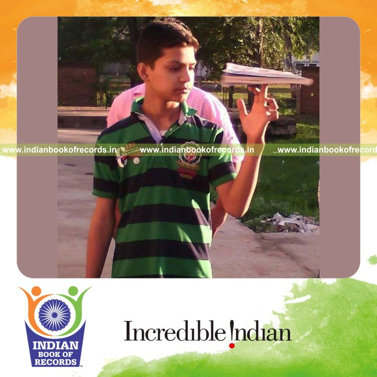 young boy spinning a book continuously for Indian Book of Records