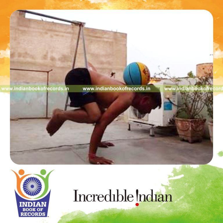 individual holding crow pose while balancing basketball on nape for record in Indian Book of Records