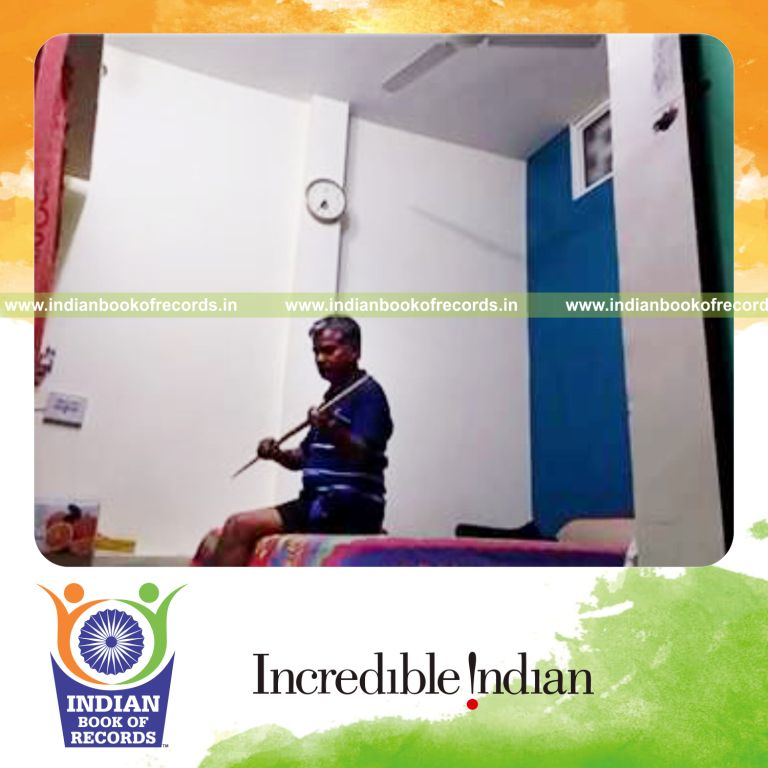 individual balancing cue stick on thumb while holding reclined thunderbolt pose for record in Indian Book of Records