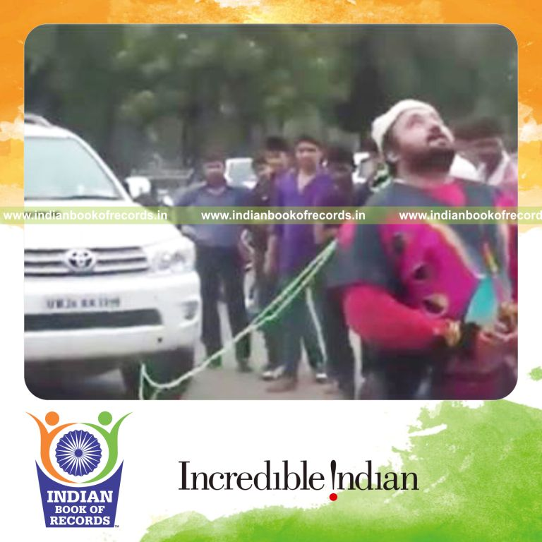 individual pulling truck and suv using hair for record in Indian Book of Records