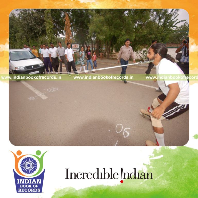 male individual pulling car with beard while on roller skates for record in Indian Book of Records