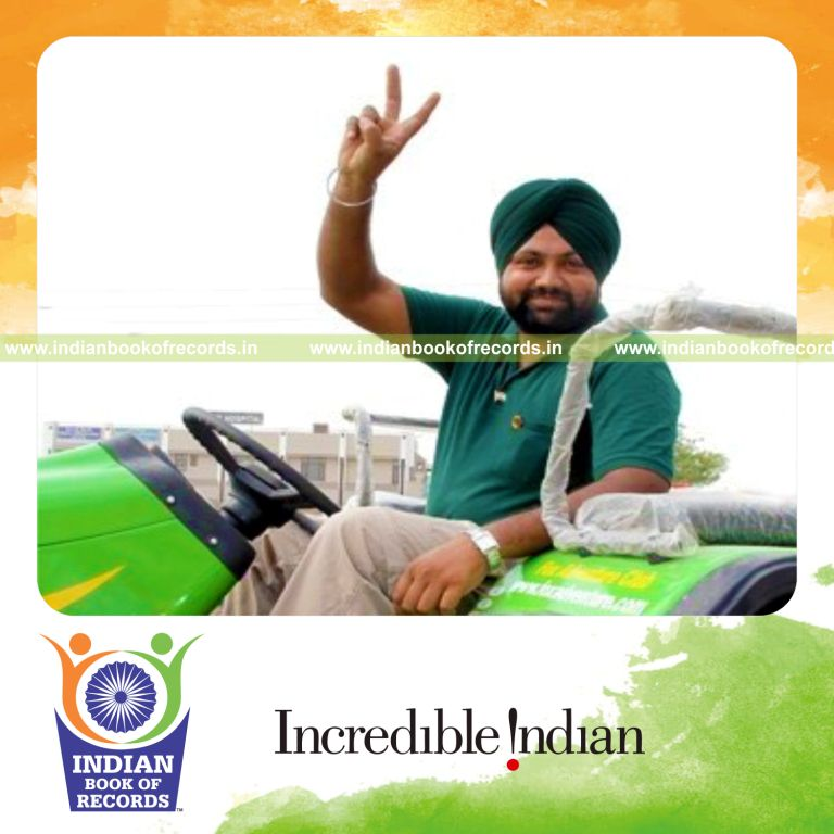 male individual driving tractor in reverse over long distance for record in Indian Book of Records