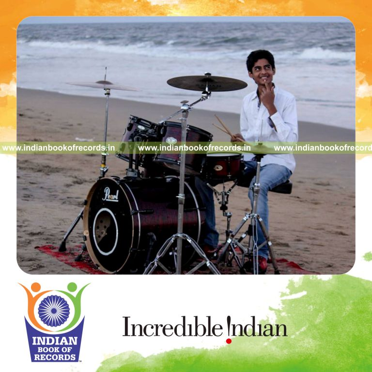 young boy performing long drumming marathon during Indian Book of Records