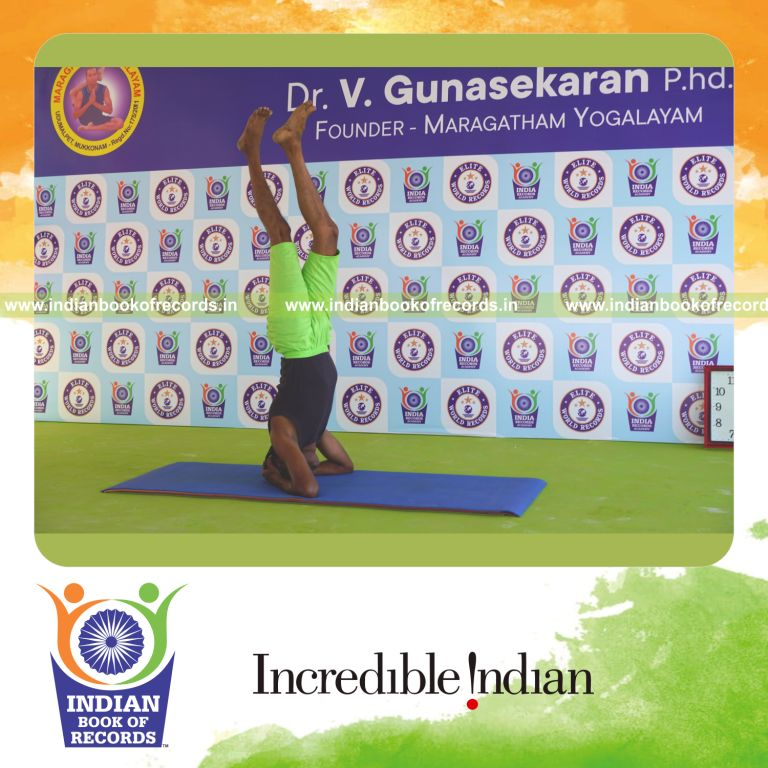 an individual holding the daksina parivrtaikapata sirsasana yoga pose continuously for the longest duration with balance for a record in Indian Book of Records