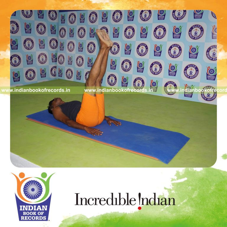 individual holding ardha halasana yoga pose blindfolded for record in Indian Book of Records