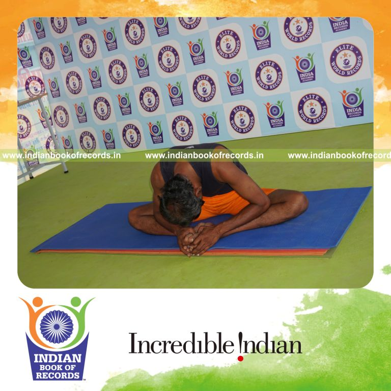 individual holding baddha konasana yoga pose blindfolded for record in Indian Book of Records