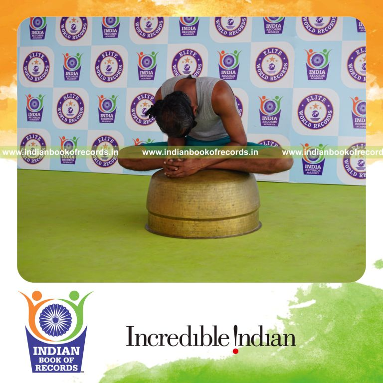 individual holding baddha konasana yoga pose blindfolded on a vessel for record in Indian Book of Records