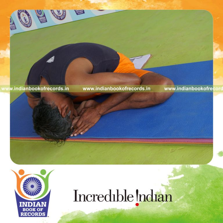 individual holding baddha konasana yoga pose for record in Indian Book of Records