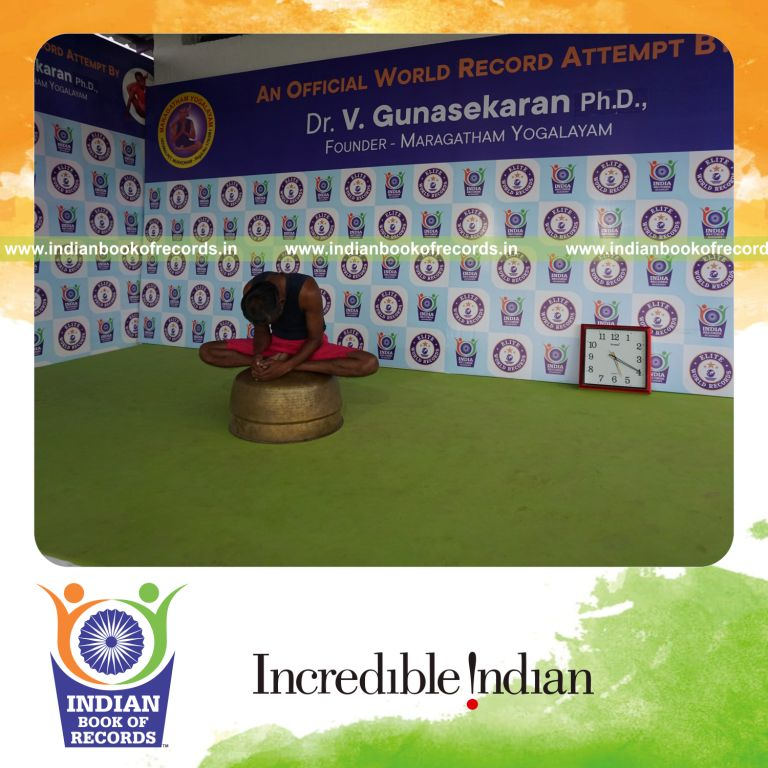 individual holding baddha konasana yoga pose on a vessel for record in Indian Book of Records