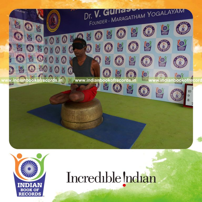 individual holding baddha padmasana yoga pose blindfolded on a vessel for record in Indian Book of Records
