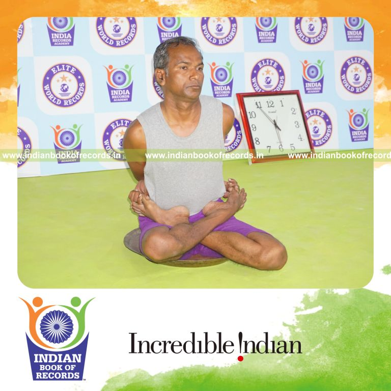 individual holding baddha padmasana yoga pose on a brass plate for record in Indian Book of Records