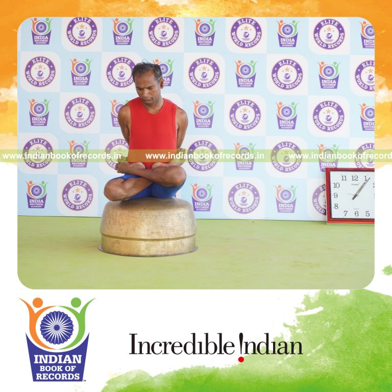 individual holding baddha padmasana yoga pose on a vessel for record in Indian Book of Records