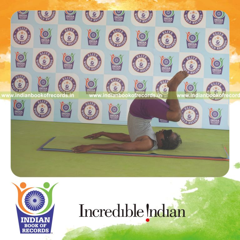 individual holding baddha salamba sarvangasana yoga pose blindfolded for record in Indian Book of Records