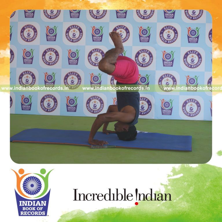 an individual holding baddha salamba sirsasana second type yoga pose blindfolded for the longest duration with strength and stability for a record in Indian Book of Records